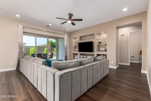 living room featuring a ceiling fan, dark wood-style floors, baseboards, built in shelves, and recessed lighting