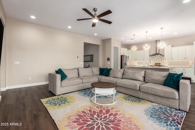 living room featuring dark wood finished floors, ceiling fan, recessed lighting, and baseboards
