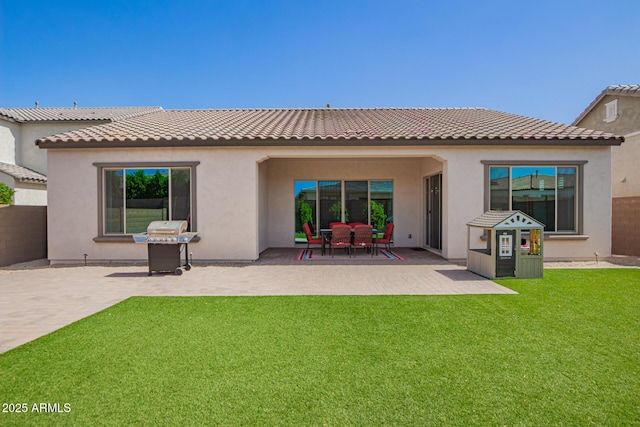back of property featuring a patio area and stucco siding