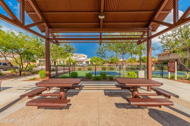 view of patio with fence, a gate, and a gazebo