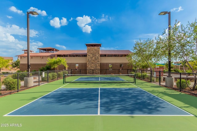 view of tennis court with fence and community basketball court