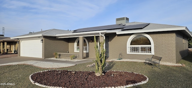 view of front of home featuring a garage, a porch, cooling unit, and solar panels