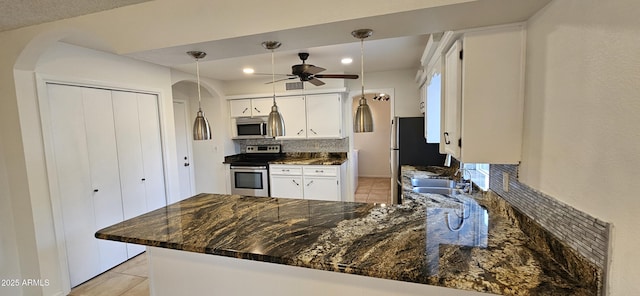 kitchen with white cabinetry, appliances with stainless steel finishes, kitchen peninsula, and sink