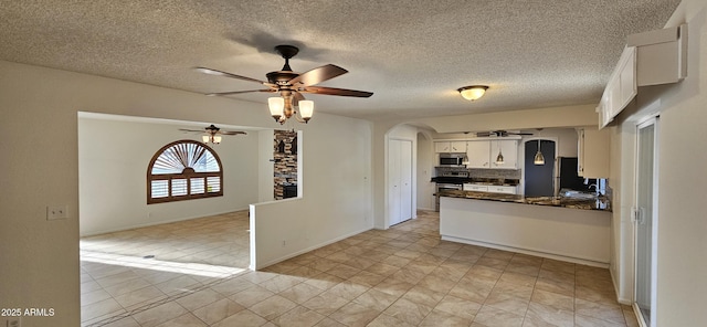 kitchen featuring stainless steel appliances, white cabinetry, ceiling fan, and kitchen peninsula