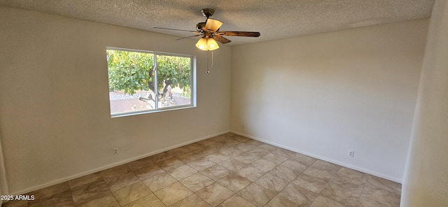 empty room featuring a textured ceiling and ceiling fan