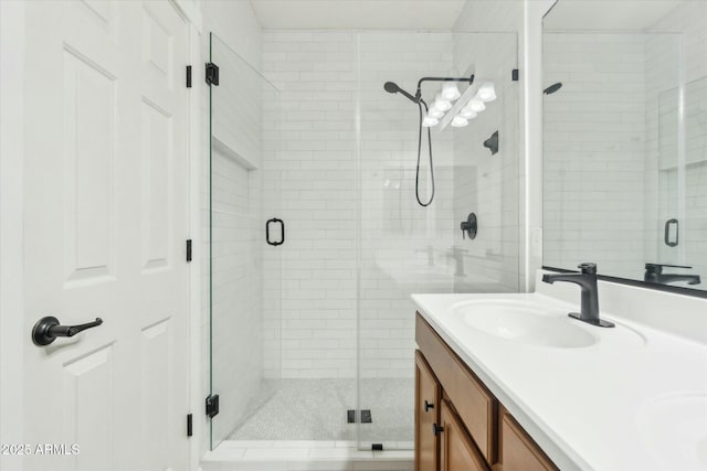 bathroom featuring walk in shower and vanity