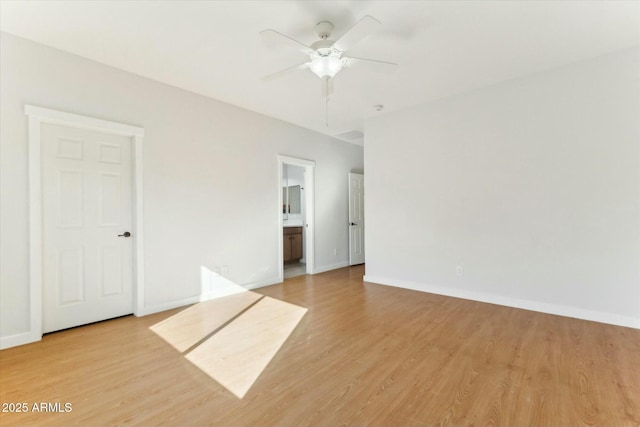 spare room featuring light hardwood / wood-style floors and ceiling fan