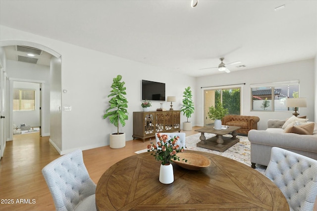 dining area with ceiling fan and light hardwood / wood-style floors