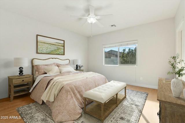 bedroom with light hardwood / wood-style flooring and ceiling fan