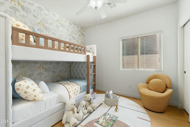 bedroom with ceiling fan and hardwood / wood-style flooring