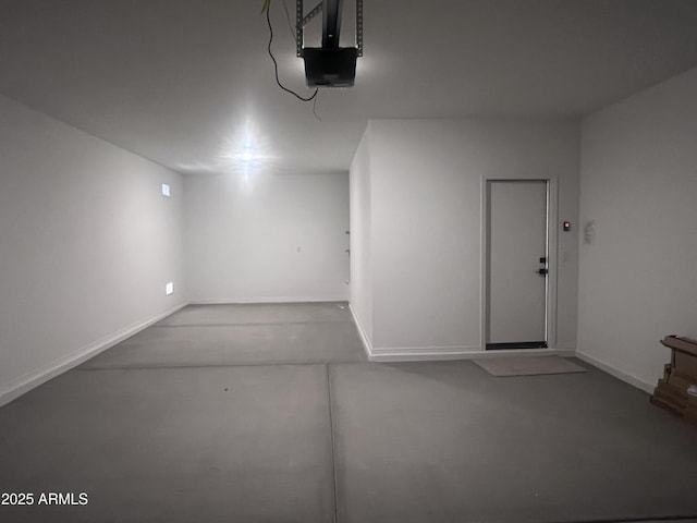 garage featuring baseboards and a garage door opener