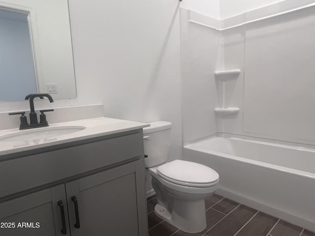 full bath featuring toilet, vanity, and shower / washtub combination