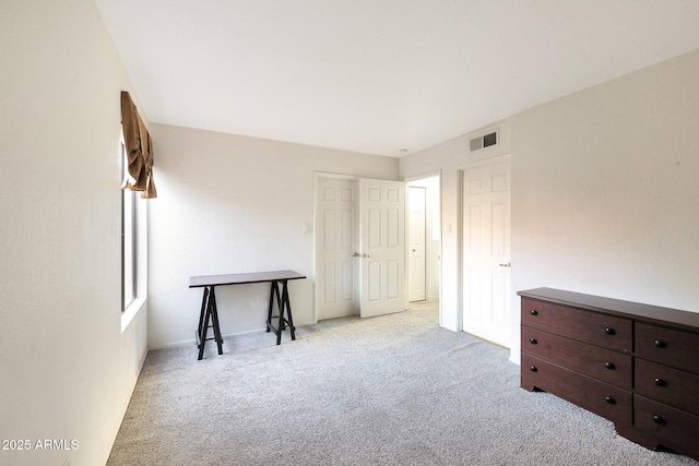 unfurnished bedroom featuring carpet floors and visible vents