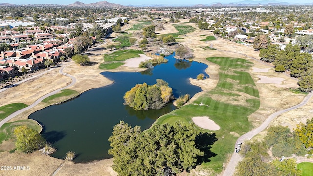 drone / aerial view featuring view of golf course, a residential view, and a water and mountain view