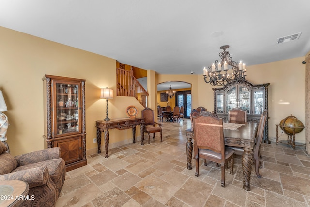 dining space featuring a notable chandelier