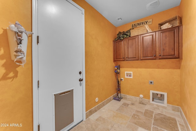 laundry area with washer hookup, hookup for a gas dryer, hookup for an electric dryer, and cabinets