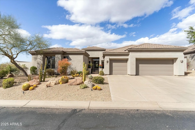 prairie-style house featuring concrete driveway, a tiled roof, an attached garage, and stucco siding