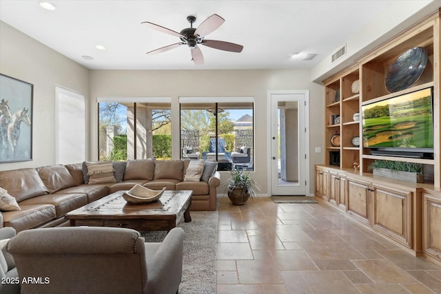 living room with visible vents, stone tile floors, recessed lighting, baseboards, and ceiling fan