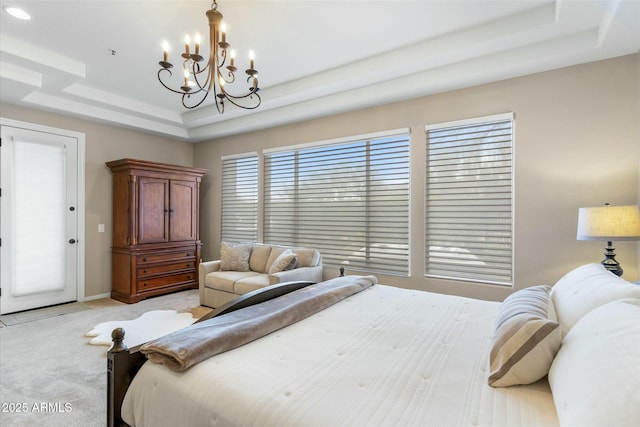 bedroom with light carpet, an inviting chandelier, baseboards, and a tray ceiling