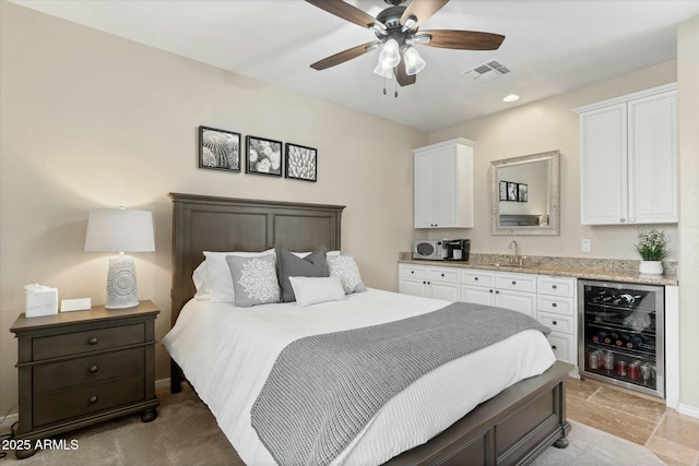 bedroom with visible vents, baseboards, wine cooler, recessed lighting, and a sink