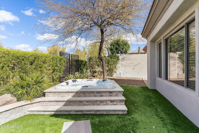 exterior space featuring a fenced backyard and an outdoor hot tub