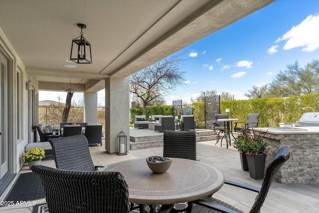 view of patio / terrace with outdoor dining space, an outdoor living space, and an outdoor kitchen