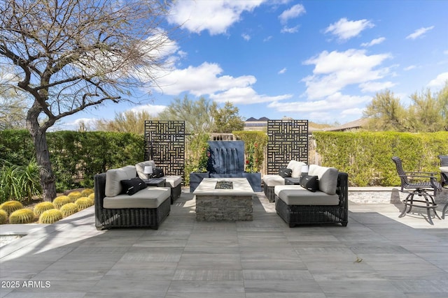 view of patio / terrace featuring an outdoor living space with a fire pit