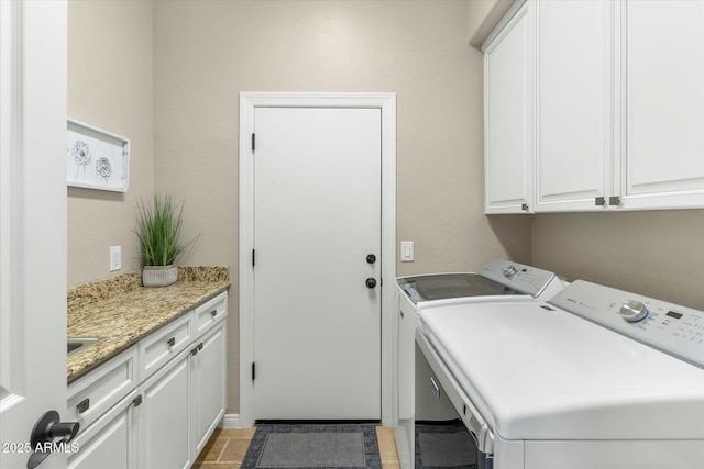 washroom with cabinet space and washing machine and dryer