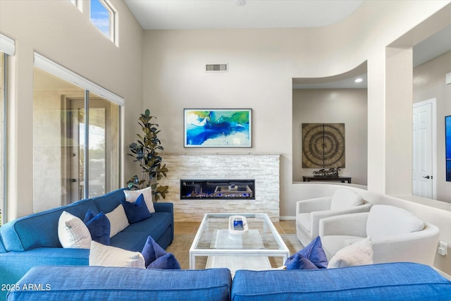 living room featuring visible vents and a fireplace