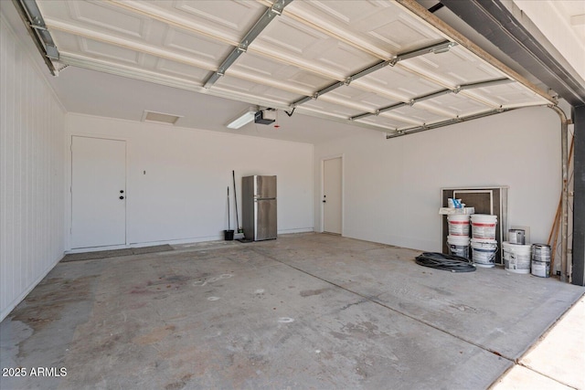 1561 N Sterling St, Mesa, AZ 85207 - garage featuring a garage door opener and freestanding refrigerator