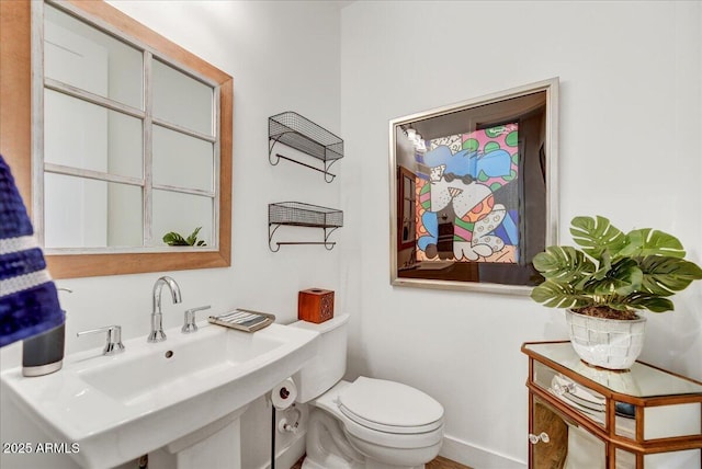 bathroom with toilet and a sink