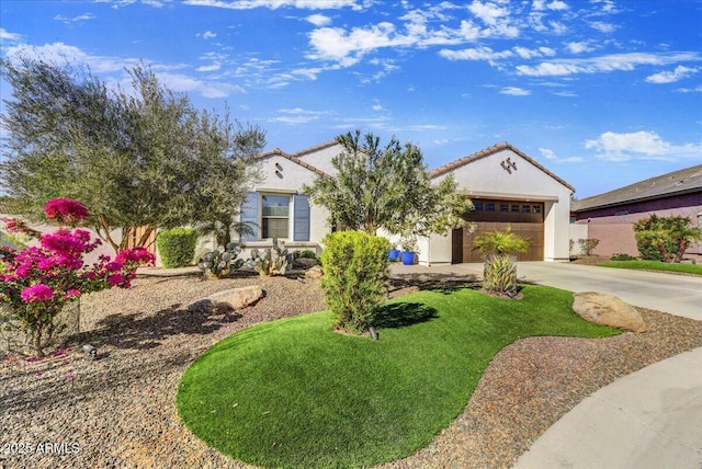 mediterranean / spanish home featuring concrete driveway, an attached garage, and stucco siding