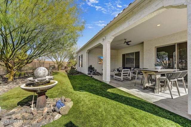 view of yard featuring a patio, ceiling fan, and fence