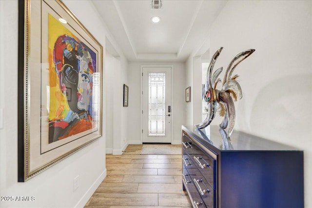 entrance foyer featuring visible vents, light wood-style floors, and baseboards