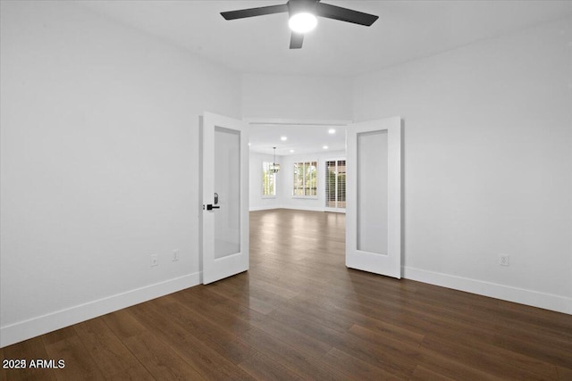 unfurnished room with ceiling fan, dark hardwood / wood-style flooring, and french doors