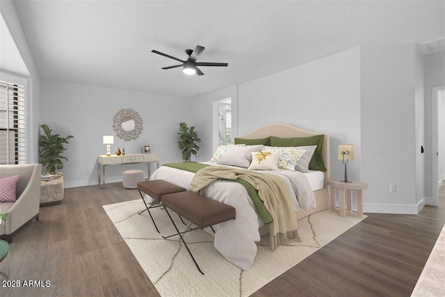 bedroom featuring multiple windows, ceiling fan, and dark wood-type flooring