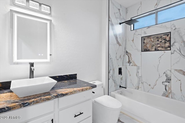 full bathroom featuring toilet, vanity, and tiled shower / bath combo