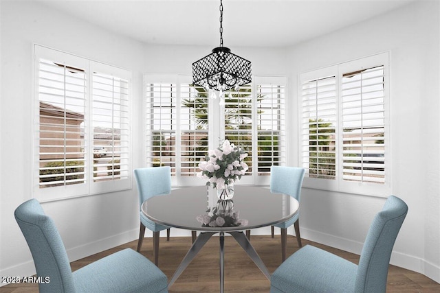 dining room with hardwood / wood-style floors and a chandelier