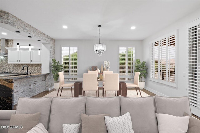 dining area featuring a chandelier and light wood-type flooring