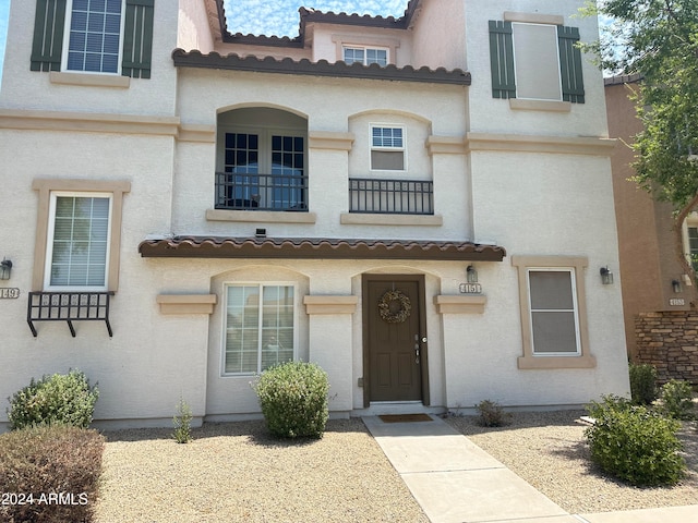 mediterranean / spanish house featuring a balcony