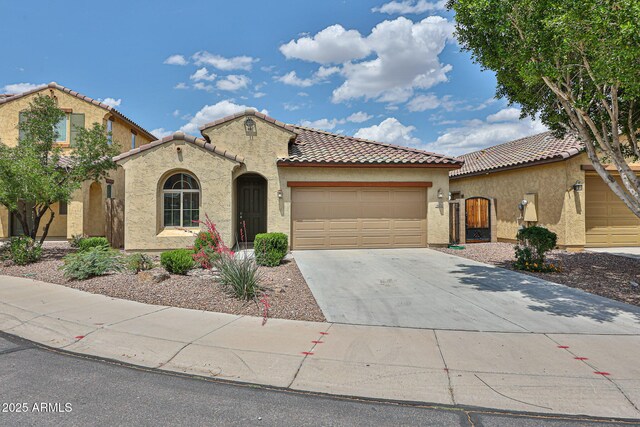 9072 W Myrtle Ave, Glendale, AZ 85305 - mediterranean / spanish home with stucco siding, an attached garage, a tiled roof, and concrete driveway