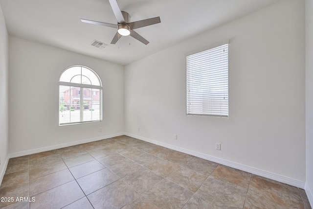 9072 W Myrtle Ave, Glendale, AZ 85305 - empty room featuring a ceiling fan, light tile patterned floors, and baseboards