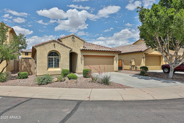 9072 W Myrtle Ave, Glendale, AZ 85305 - mediterranean / spanish-style home with stucco siding, a tile roof, a garage, fence, and driveway