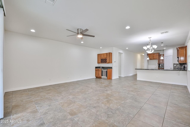 9072 W Myrtle Ave, Glendale, AZ 85305 - unfurnished living room featuring a chandelier, recessed lighting, a ceiling fan, a sink, and baseboards