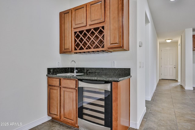 9072 W Myrtle Ave, Glendale, AZ 85305 - indoor wet bar with wine cooler, baseboards, and light tile patterned floors