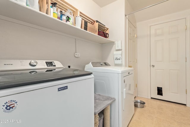 washroom with laundry area, washer and clothes dryer, and light tile patterned floors