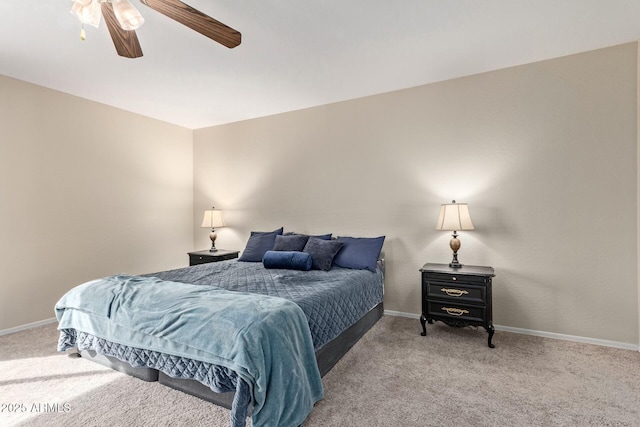 bedroom with a ceiling fan, light carpet, and baseboards