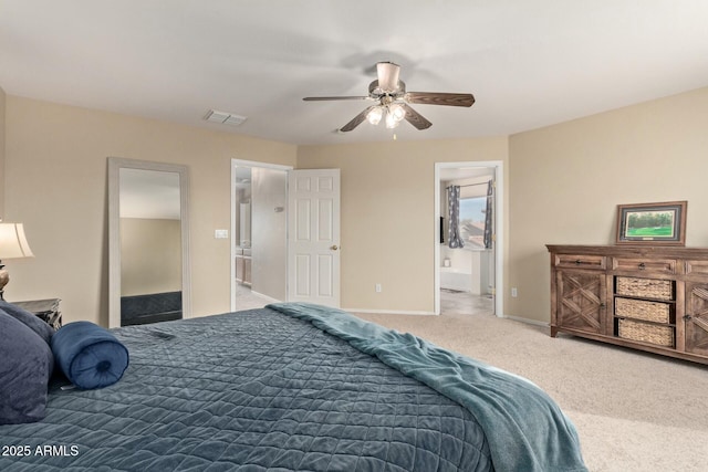 carpeted bedroom with a ceiling fan, visible vents, ensuite bath, and baseboards