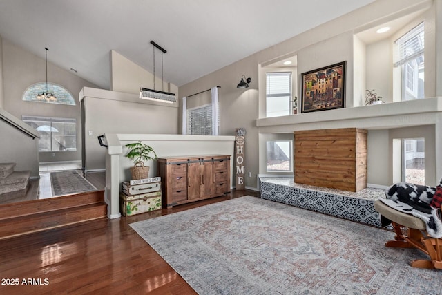 entryway featuring high vaulted ceiling, stairway, dark wood finished floors, and baseboards