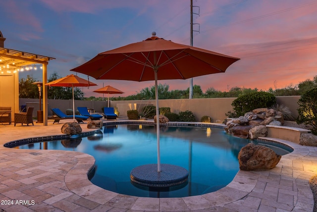 pool at dusk with a patio